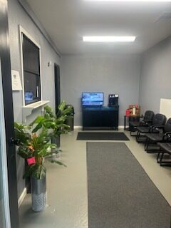 Comfortable waiting room with seating and TV